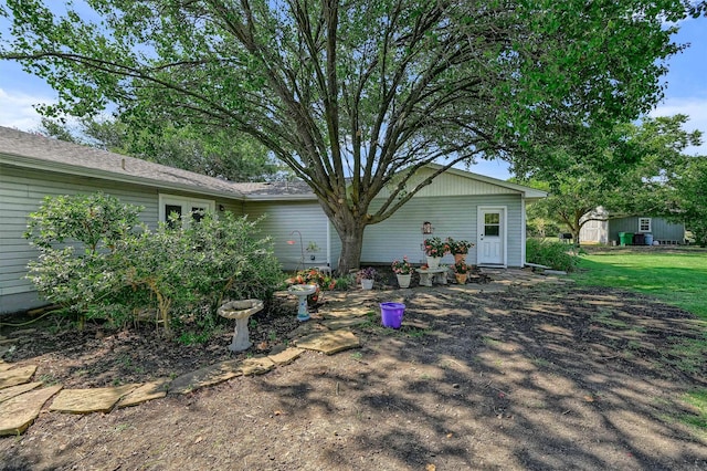 back of property with a storage unit