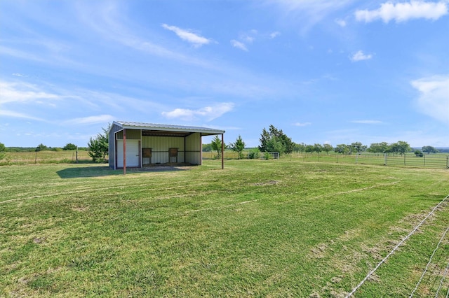 view of yard featuring a rural view and an outdoor structure