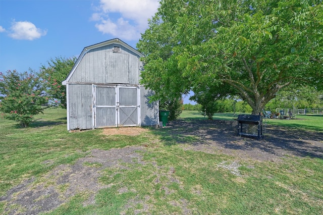 view of outbuilding featuring a yard