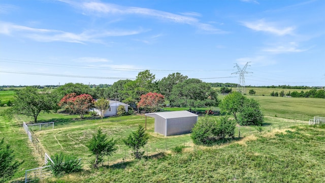 view of yard with a rural view and an outbuilding