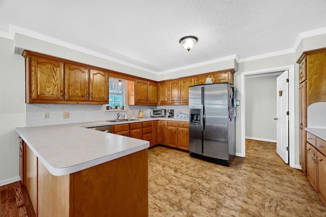 kitchen featuring sink, kitchen peninsula, crown molding, stainless steel fridge with ice dispenser, and a textured ceiling