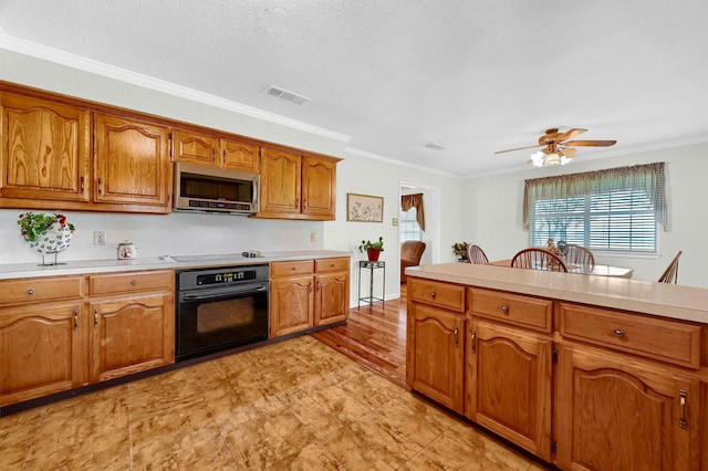 kitchen with ceiling fan, oven, crown molding, cooktop, and a textured ceiling