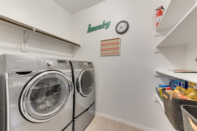 laundry area with separate washer and dryer and light tile patterned floors