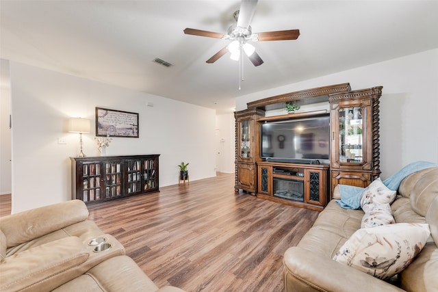 living room with hardwood / wood-style floors and ceiling fan