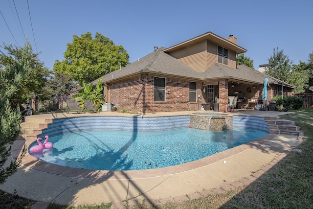 view of swimming pool featuring an in ground hot tub and a patio