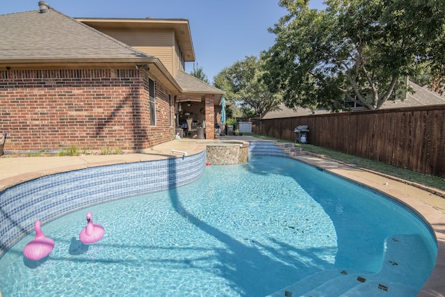 view of pool with a patio and an in ground hot tub