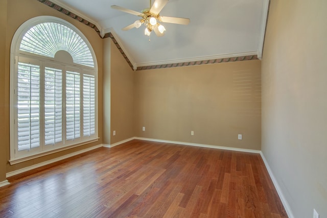 spare room featuring wood-type flooring, lofted ceiling, crown molding, and ceiling fan