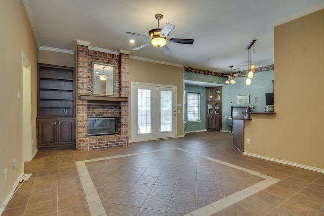 unfurnished living room featuring a fireplace, ornamental molding, light tile patterned floors, ceiling fan, and built in shelves