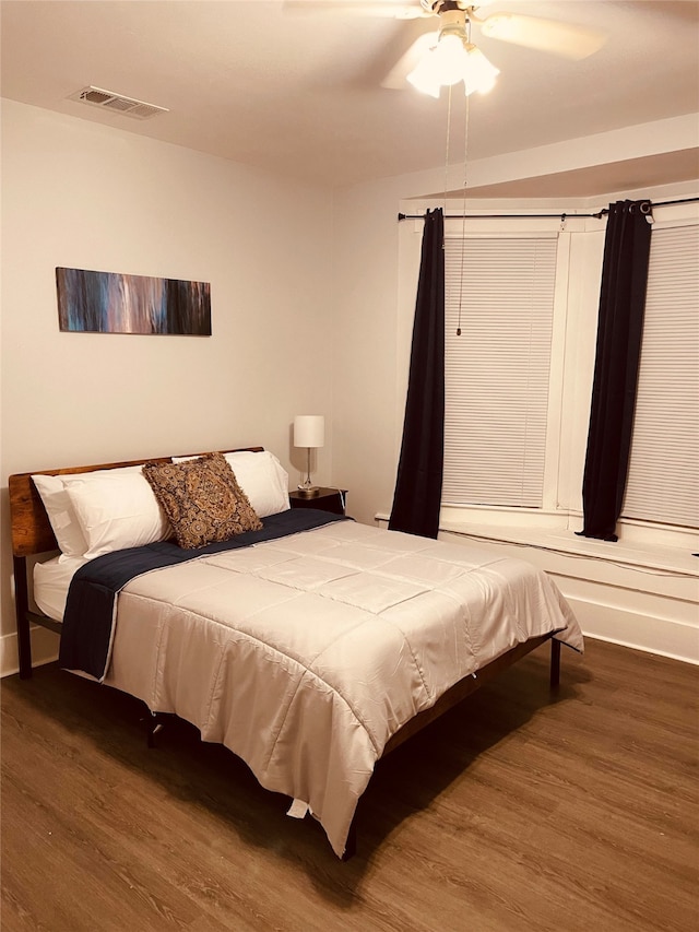 bedroom featuring ceiling fan and dark hardwood / wood-style floors