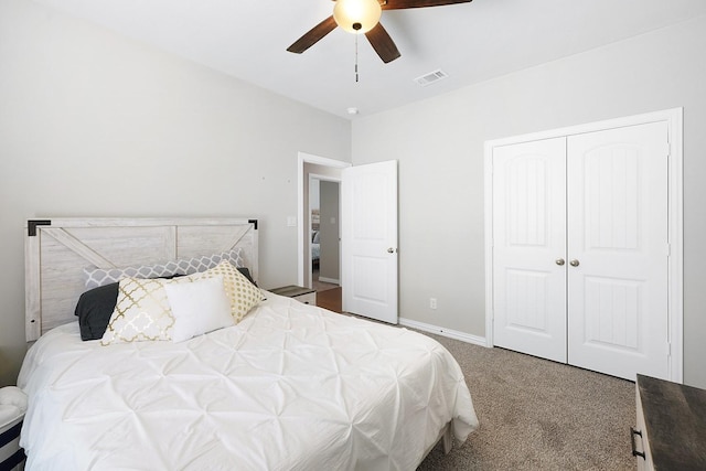 carpeted bedroom with a ceiling fan, baseboards, visible vents, and a closet