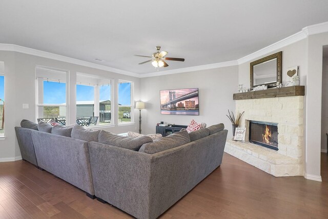 living area with a stone fireplace, recessed lighting, a ceiling fan, light wood finished floors, and crown molding