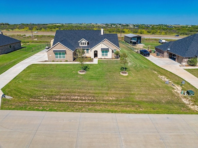 view of front of house featuring fence, concrete driveway, and a front yard