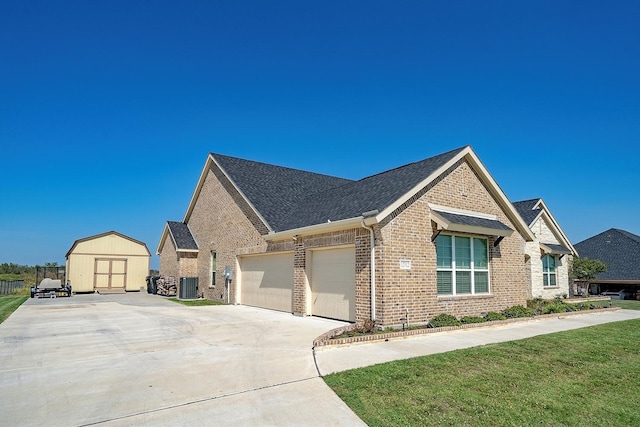 view of front of home with central AC unit, a front lawn, and a storage unit