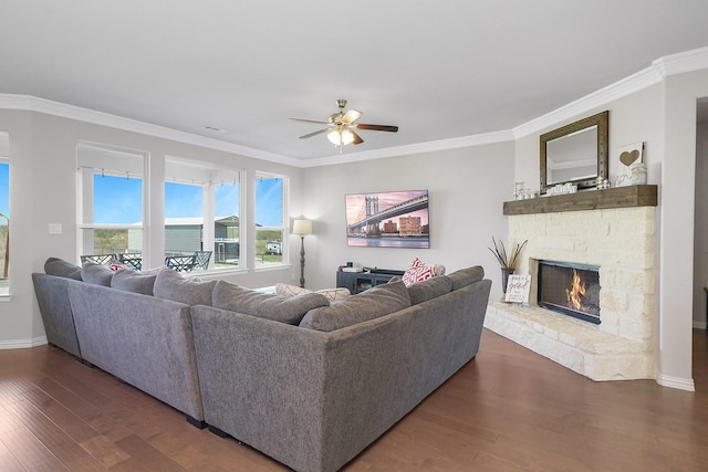 living area featuring baseboards, a fireplace, dark wood finished floors, and crown molding