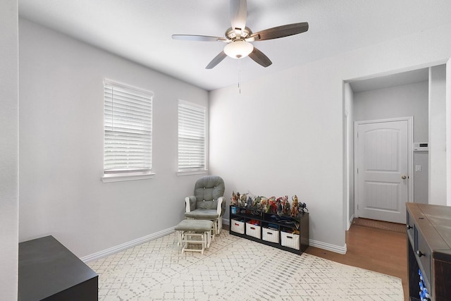 sitting room featuring hardwood / wood-style flooring and ceiling fan