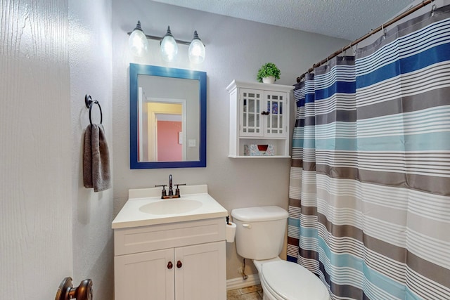 bathroom with toilet, a textured ceiling, curtained shower, and vanity