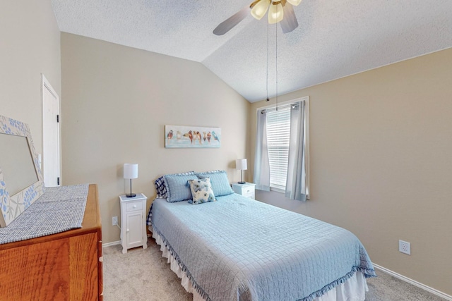 carpeted bedroom featuring vaulted ceiling, a textured ceiling, and ceiling fan