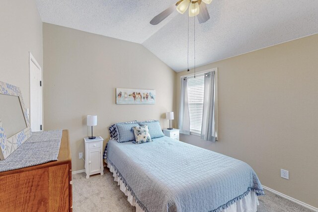 carpeted bedroom with vaulted ceiling and ceiling fan