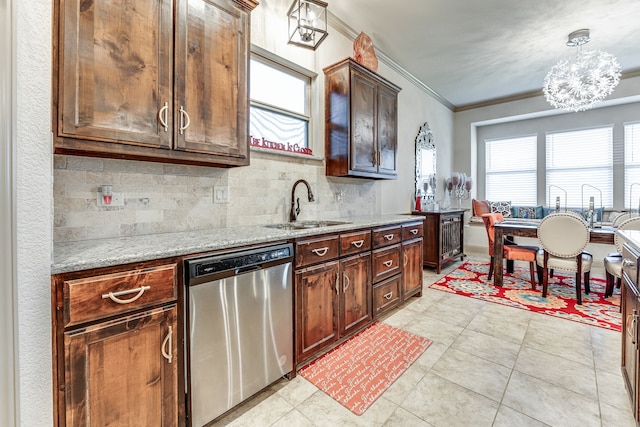 kitchen with sink, hanging light fixtures, stainless steel dishwasher, ornamental molding, and light stone countertops