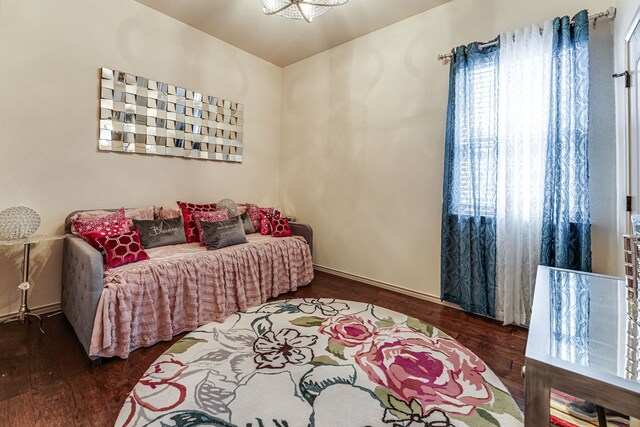 bedroom featuring wood finished floors and baseboards