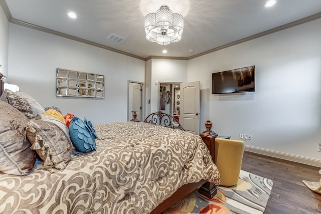 bedroom with hardwood / wood-style flooring, crown molding, and a closet