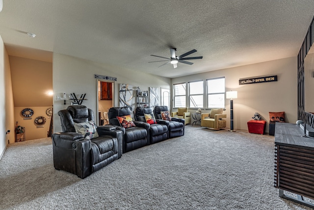 carpeted living area featuring a ceiling fan and a textured ceiling