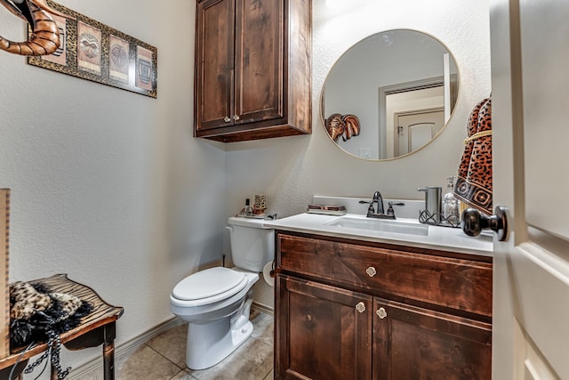 bathroom featuring tile patterned floors, toilet, and vanity