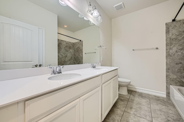 full bathroom featuring toilet, vanity, tile patterned floors, and tiled shower / bath combo