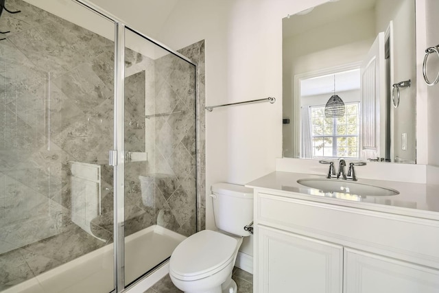 bathroom featuring vanity, an enclosed shower, and toilet