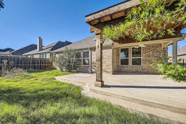 back of property featuring a yard and a patio area