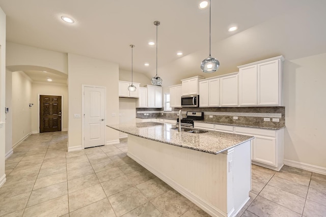 kitchen featuring a kitchen island with sink, white cabinets, sink, stone countertops, and stainless steel appliances