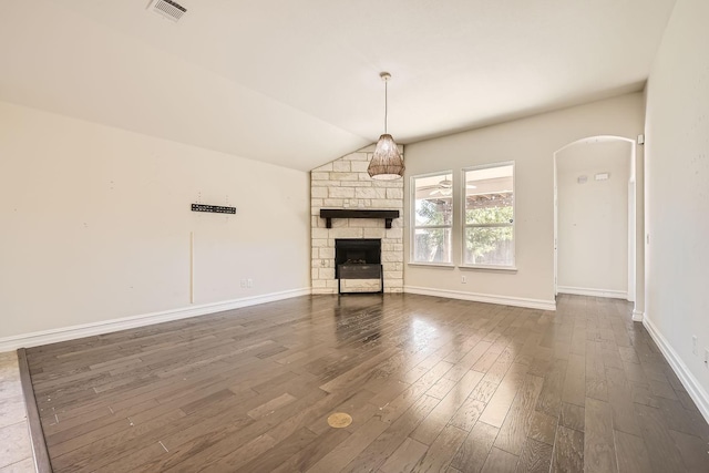 unfurnished living room with a fireplace, dark hardwood / wood-style floors, and lofted ceiling