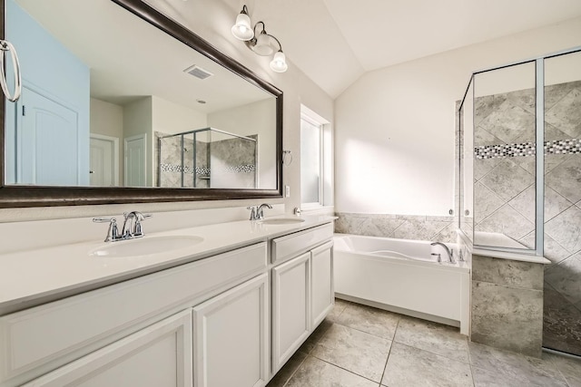 bathroom with tile patterned flooring, vanity, vaulted ceiling, and shower with separate bathtub