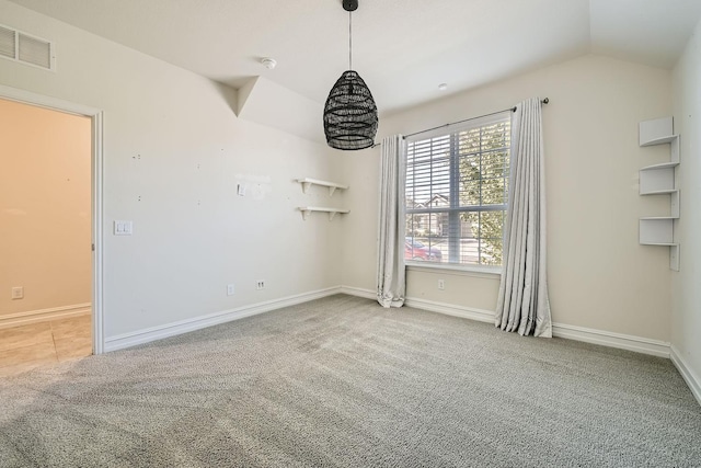 empty room with light carpet and vaulted ceiling