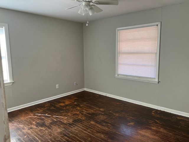 unfurnished room featuring ceiling fan and dark wood-type flooring