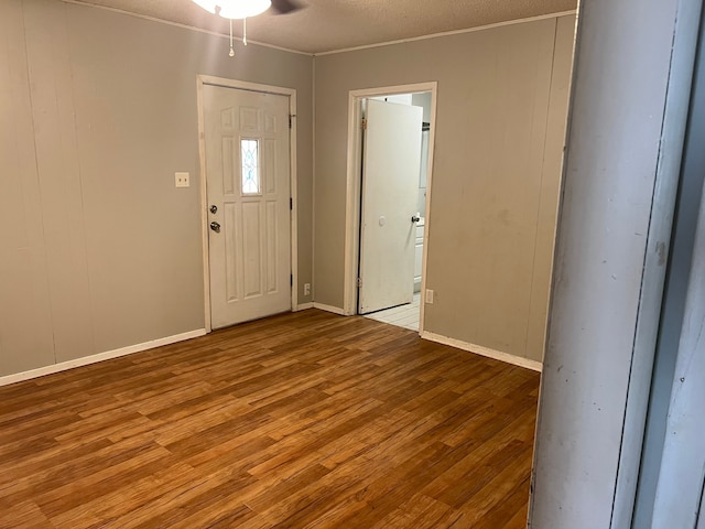 foyer with ceiling fan, a textured ceiling, and light hardwood / wood-style floors