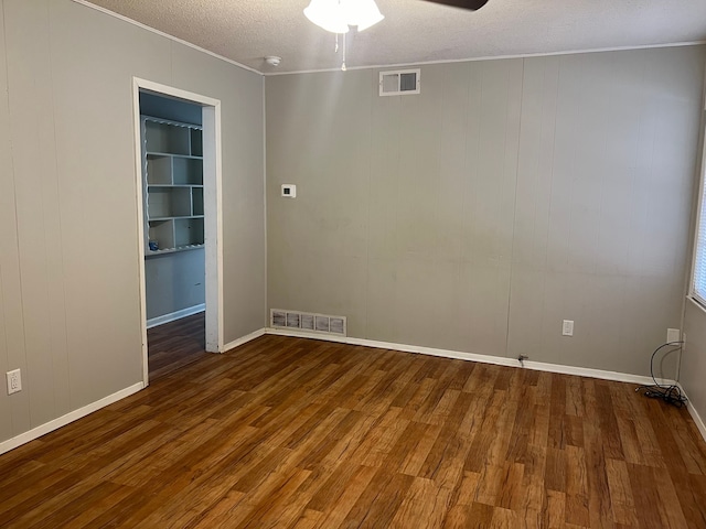 spare room featuring a textured ceiling, ceiling fan, and hardwood / wood-style flooring