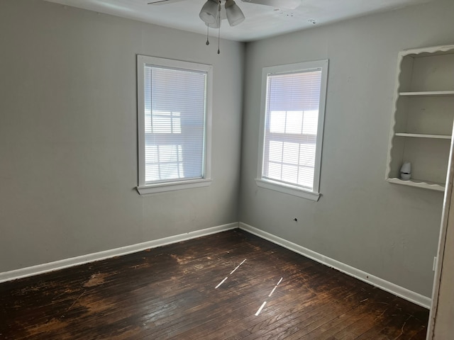 spare room featuring ceiling fan and dark wood-type flooring