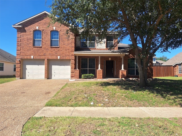 view of front of property with a front yard and a garage