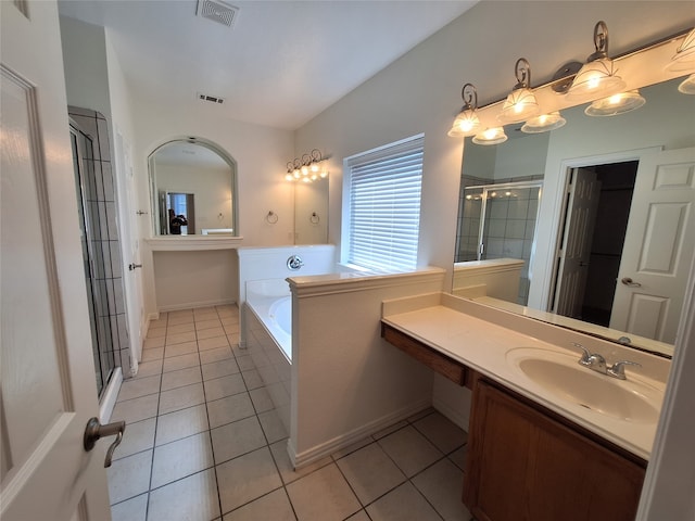 bathroom with tile patterned floors, vanity, and separate shower and tub