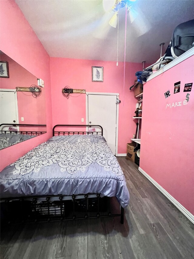 bedroom with wood-type flooring and ceiling fan