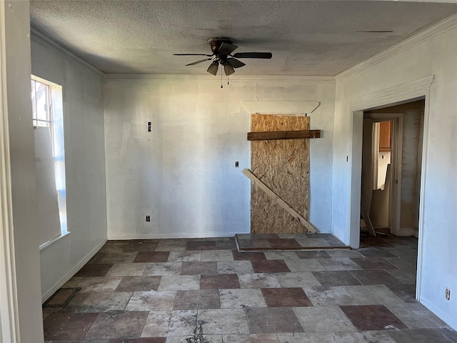 empty room with ornamental molding, ceiling fan, and a textured ceiling