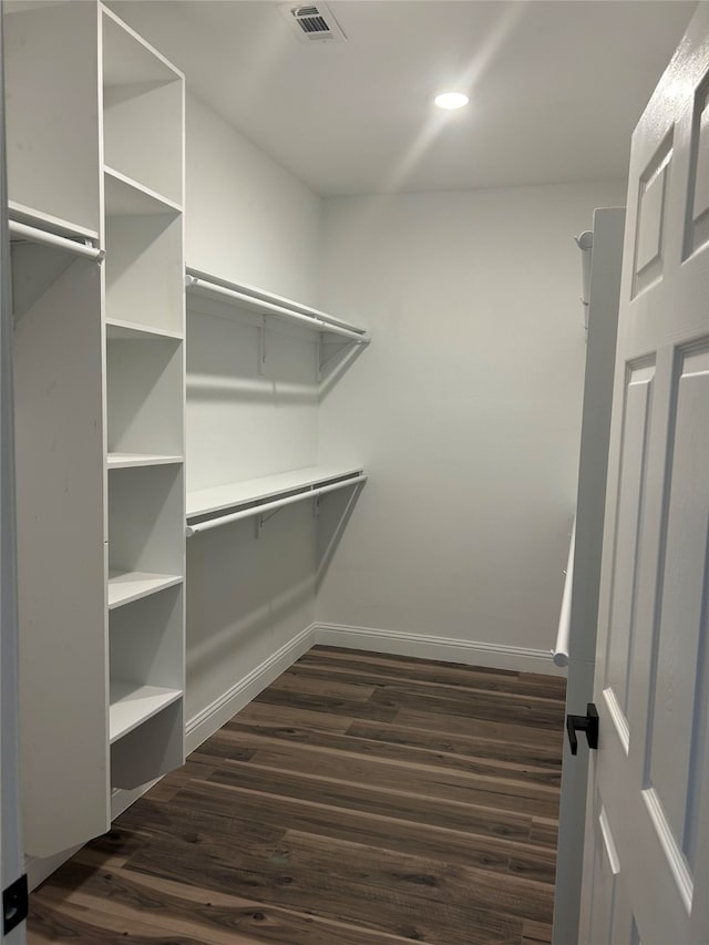 walk in closet featuring dark wood-type flooring