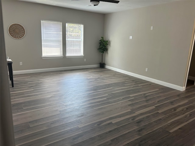 spare room with dark hardwood / wood-style flooring and ceiling fan