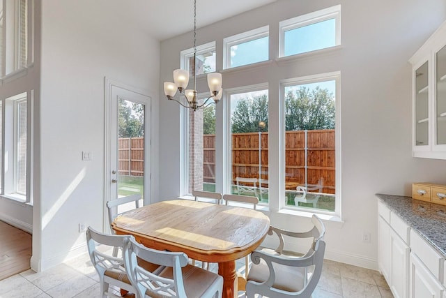 dining space featuring light tile patterned floors and a chandelier