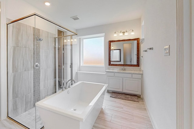 bathroom featuring vanity and plus walk in shower