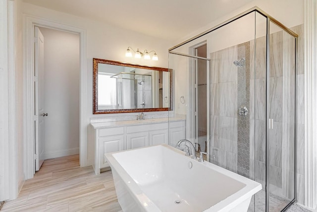 bathroom featuring vanity and independent shower and bath