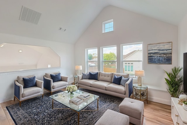 living room with vaulted ceiling and light hardwood / wood-style flooring