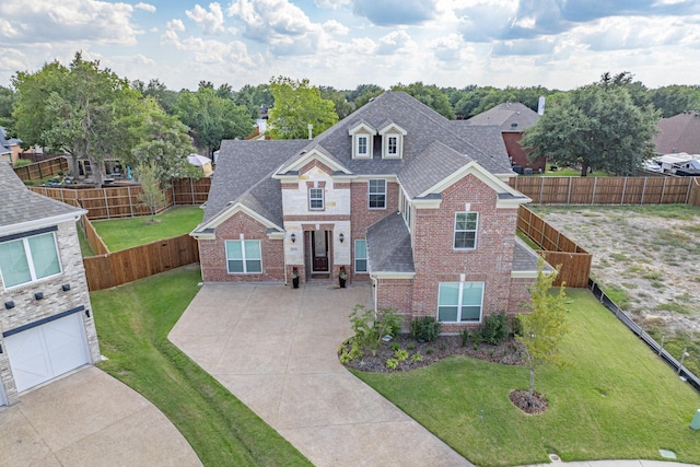 view of front of home with a garage and a front lawn