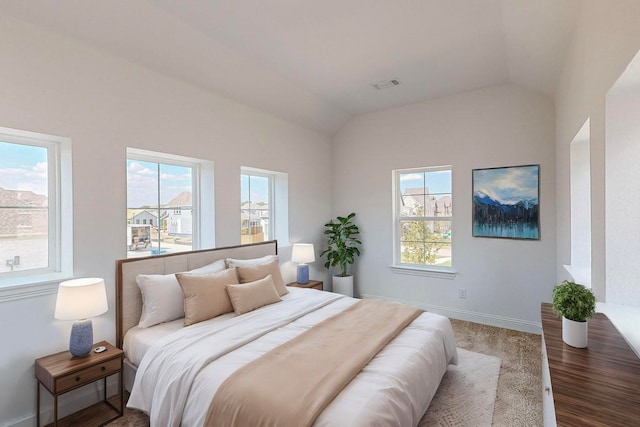 bedroom with hardwood / wood-style floors and vaulted ceiling